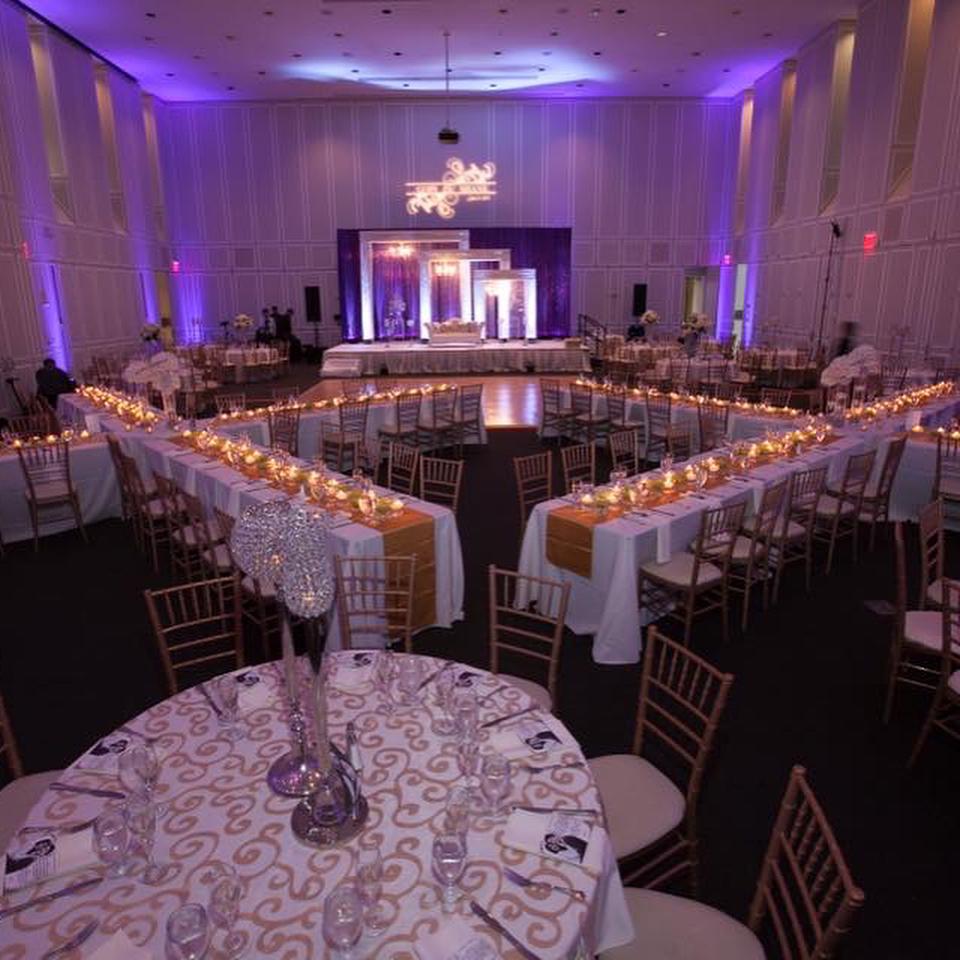 Elegant setting with rectangular long tables set in X formation 