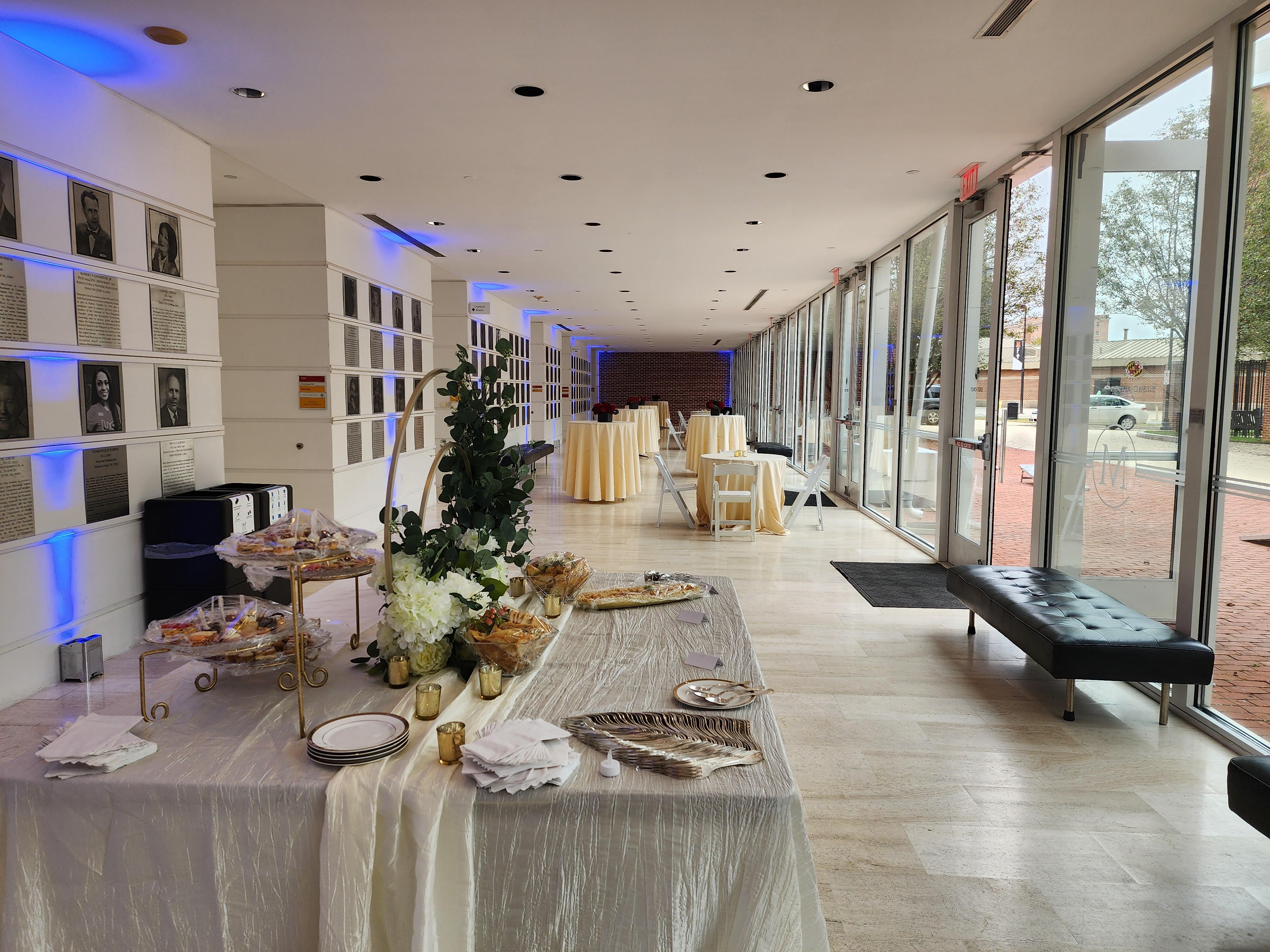 Reception in marble hall with food spread and cream linens