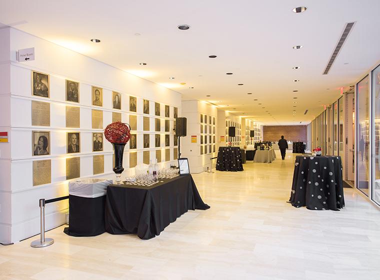 Marble hall with black draped tables and red florals