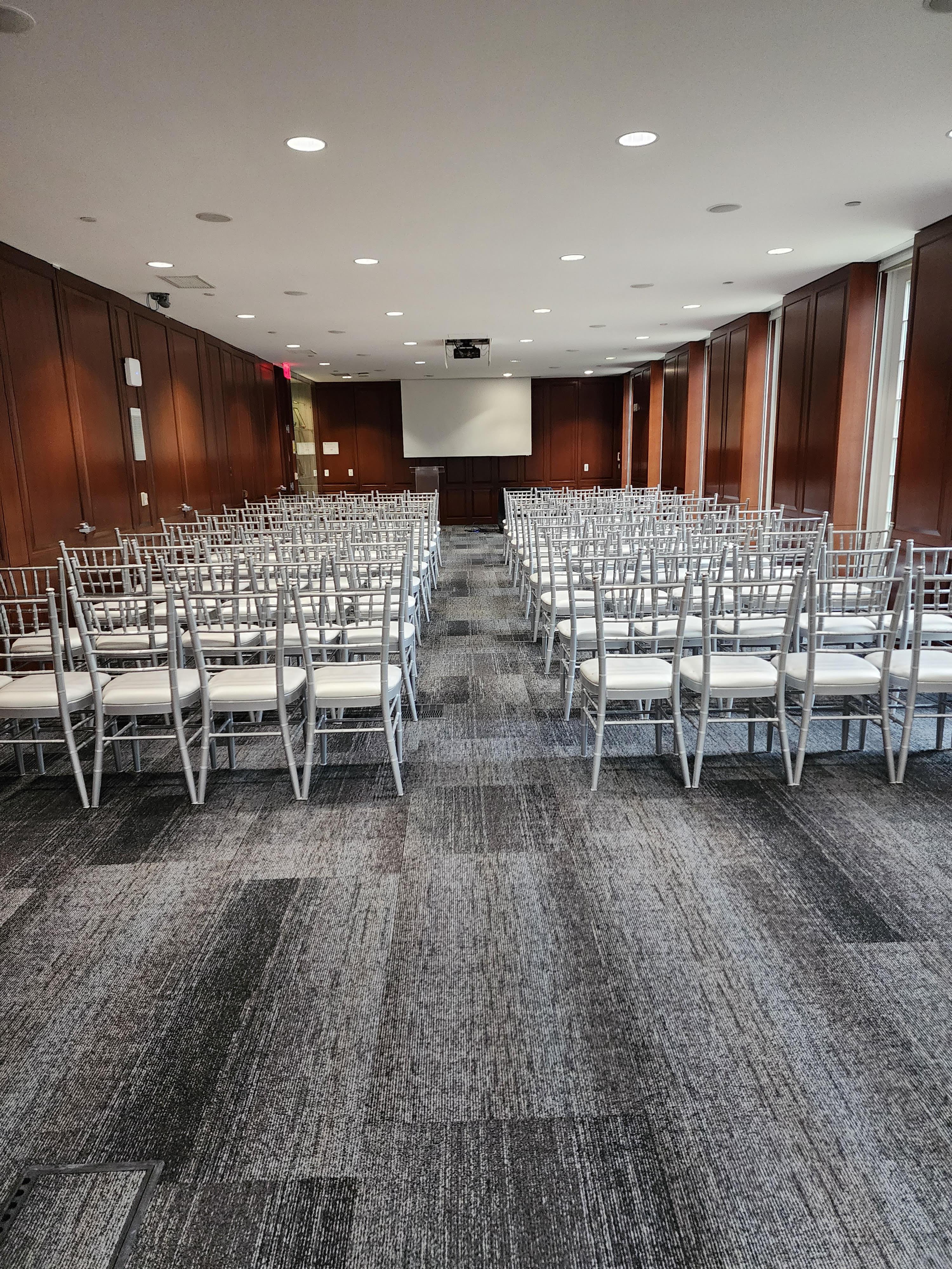 Long room set theater style with silver chivari chairs