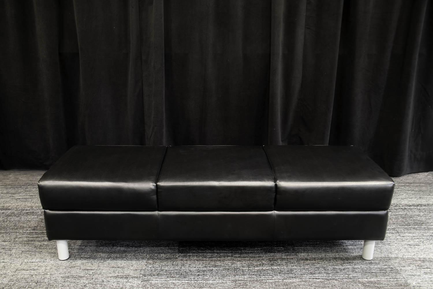 Black cushioned bench. Movable.