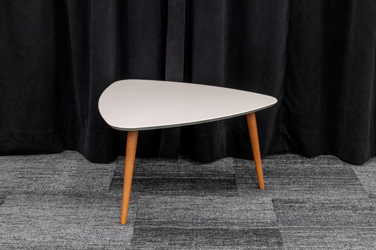 Three Legged Triangle plastic coffee table with wooden legs. 